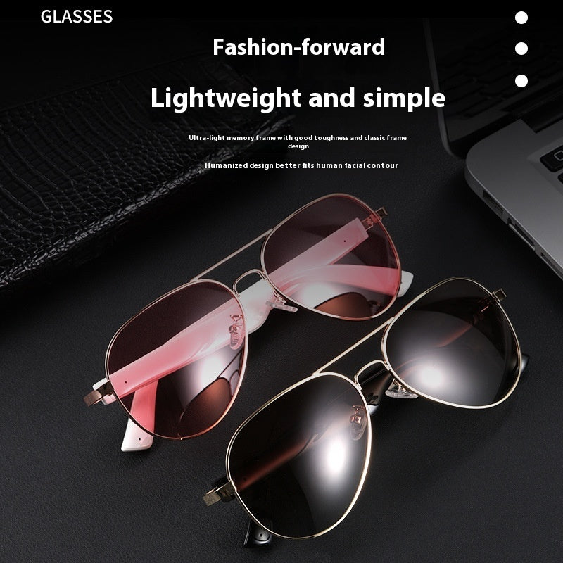 Pair of sunglasses with pink and black lenses on a dark surface